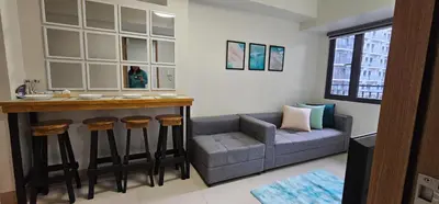 a living room with a bar and a couch at 2 Bedroom Mall of Asia and Airport in Manila