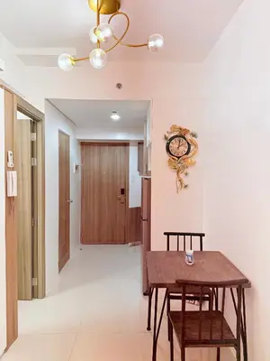 a dining room with a table and a clock on the wall at Nestled Haven in Manila
