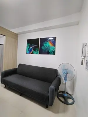 a living room with a couch and a fan at 2 Bedrooms 1CR Shore 1 Residences upto 7 person-15mins walk to MOA in Manila