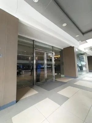 an empty lobby of an office building with glass doors at 2 Bedrooms 1CR Shore 1 Residences upto 7 person-15mins walk to MOA in Manila