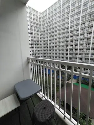 a balcony with a bench and a large building at 2 Bedrooms 1CR Shore 1 Residences upto 7 person-15mins walk to MOA in Manila