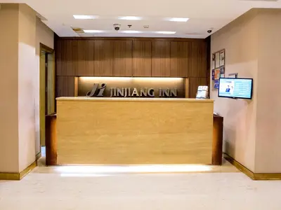 a lobby with aitating inn sign on the wall at Jinjiang Inn - Ortigas in Manila