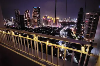a view of a city skyline at night at Boho City View 1br Apt in Makati with Netflix in Manila