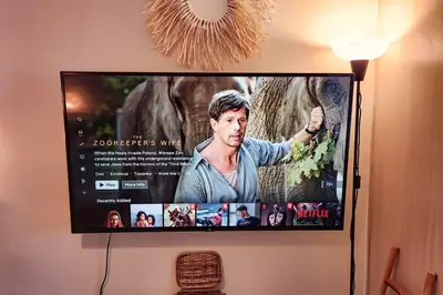 a flat screen tv hanging on a wall at Boho City View 1br Apt in Makati with Netflix in Manila