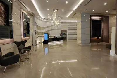 a lobby with chairs and a television in a building at Boho City View 1br Apt in Makati with Netflix in Manila