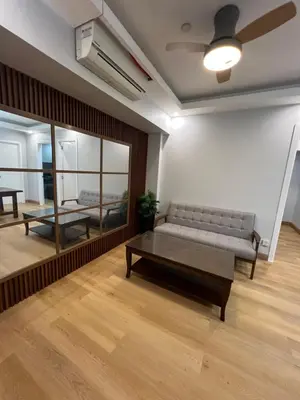 a living room with a couch and a table at Acqua Escape in Manila