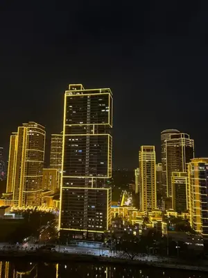 a city lit up at night with tall buildings at Acqua Escape in Manila