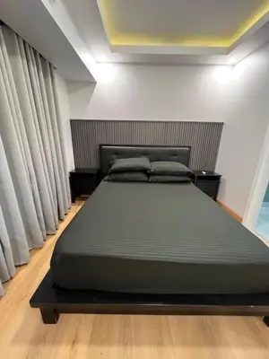 a bedroom with a large bed in a room at Acqua Escape in Manila