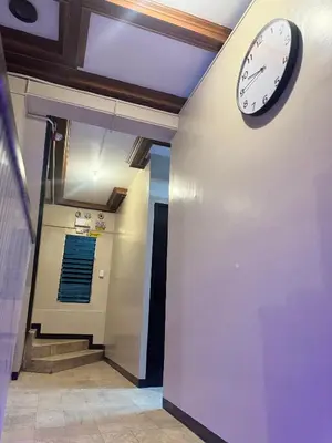 a clock on a wall in a hallway at 88Ap Lodging House San Marcelino in Manila