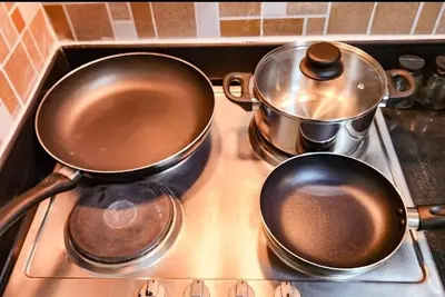 two pots and pans sitting on top of a stove at Gaming 2br in Makati with City View Arcade Netflix in Manila