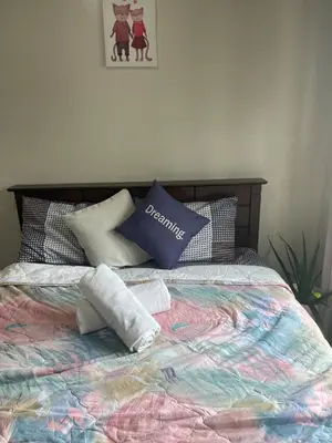 a bed with towels and pillows on it at 52sqmComfy2BR and 2BA Resort-inspired Flair Towers Condo in Manila