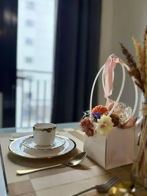 a table with a cup and a plate with a tea set at CASA BELLA - Shore 3 MOA, Pasay in Manila