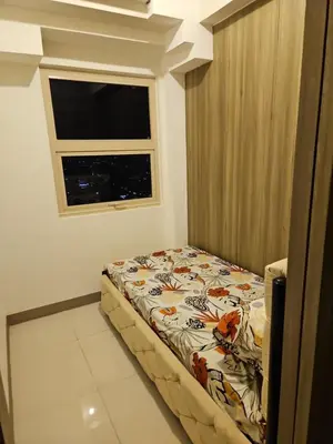 a small bed in a room with a window at Condo next door 3 in Manila