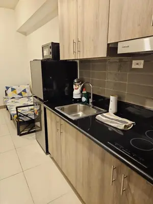 a kitchen with a sink and a microwave at Condo next door 3 in Manila