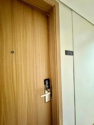 a door in a room with a sign on it at Minimalist Chic Condo near MOA-Shore3 Tower2 in Manila