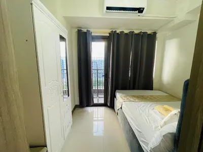 a small room with two beds and a window at 1126 S Residences SMDC Condo near W Mall & MOA by Prime Stay in Manila
