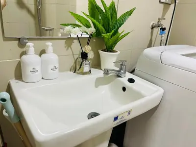 a bathroom sink with two bottles on top of it at 1126 S Residences SMDC Condo near W Mall & MOA by Prime Stay in Manila