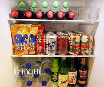 a refrigerator filled with lots of drinks and soda at Azure Staycation in Manila