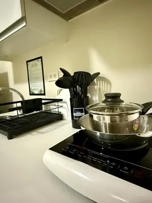 a kitchen counter with a pot on a stove at Verte Hideaway at Azure Residences - Urban Escape in Manila