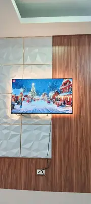 a flat screen tv hanging on a wall at Casa Viana - Modern House Upto 300mbps Wi-fi with Netflix, FREE Parking in Cabuyao
