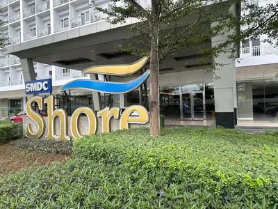 a store sign in front of a building at Modern Studio Condo - Shore near MOA- 403B in Manila