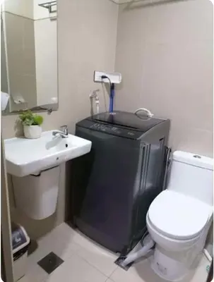 a small bathroom with a toilet and a sink at S residence, Mall of Asia Area in Manila