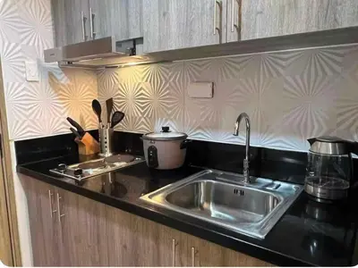 a kitchen with a sink and a counter top at S residence, Mall of Asia Area in Manila