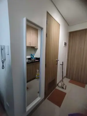a room with a door leading to a kitchen at Cozy Apartment in Mall of Asia in Manila