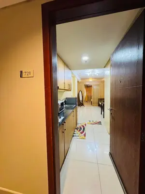 a kitchen with a door open to a living room at Shell Residences Tower A in Manila