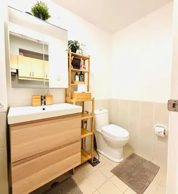 a bathroom with a sink and a toilet at Free Car Parking - Sheridan North 1BR Apt near BGC in Manila