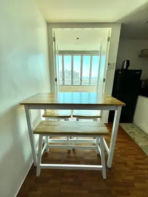 a table with a bench in a room with a window at Loft in Boni - Work friendly - Cityview - up to 8pax in Manila