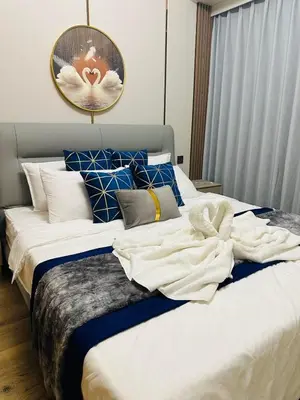 a bedroom with a large bed with towels on it at Savvy Suites Combined 6BR near Okada in Manila