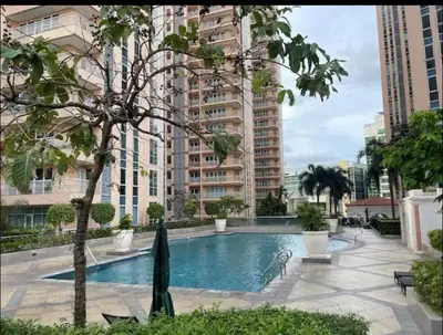 a swimming pool in a city with tall buildings at Cozy Home at Venice Luxury BGC in Manila