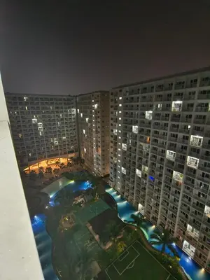 an aerial view of a large building at night at Shore Condotel Metro Staycation in Manila
