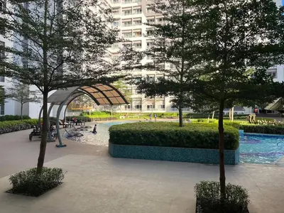 a park with trees in front of a building at VM Staycation Tower 3 Grace Residence Taguig in Manila