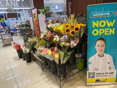 a flower shop with a sign next to a bunch of flowers at Family Oasis Makati 2 bedroom 1 kiddo room 300 mbps Fast Net in Manila
