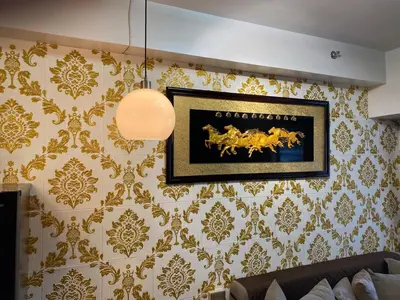 a living room with a picture on the wall at Family Oasis Makati 2 bedroom 1 kiddo room 300 mbps Fast Net in Manila