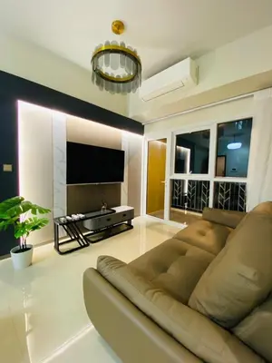 a living room with a couch and a flat screen tv at Savvy Suites 2BR Okada View in Manila