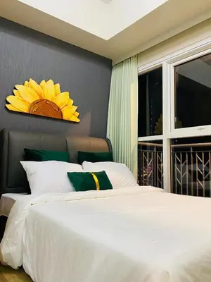 a bedroom with a large white bed and a window at Savvy Suites 2BR Okada View in Manila