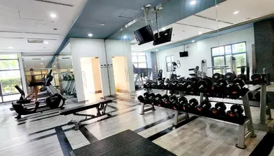 a gym with a lot of equipment in a room at 14F BGC Unit 3 mins Walk to The Venice Grand Canal Mall Pet Friendly in Manila