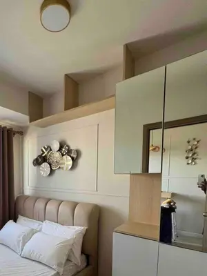 a bedroom with a bed and a mirror at Stylist hideaway in d heart of MOA in Manila