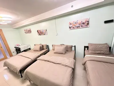 a hospital room with four beds in a row at Kathys Crib Family Suite Room at Shell Residence in Manila