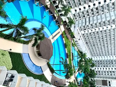 an overhead view of a large building with a swimming pool at Kathys Crib Family Suite Room at Shell Residence in Manila