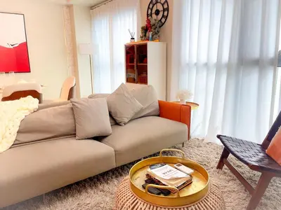 a living room with a couch and a table at Luxury Apartment near Okada Manila and Solaire in Manila