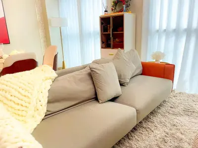 a living room with a couch with a blanket on it at Luxury Apartment near Okada Manila and Solaire in Manila