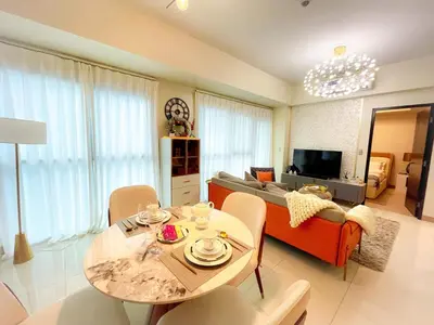 a living room with a table and a couch at Luxury Apartment near Okada Manila and Solaire in Manila