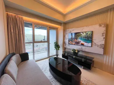 a living room with a couch and a table at Luxury 1BR across Okada, Solaire in Manila