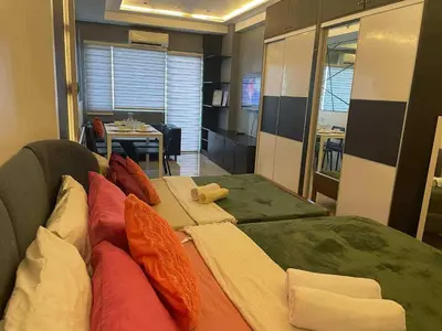 a room with a couch with pillows and a table at Kys 3 staycation near NAIA mall of asia in Manila
