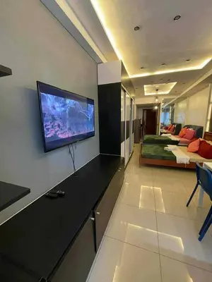 a living room with a flat screen tv on a wall at Kys 3 staycation near NAIA mall of asia in Manila