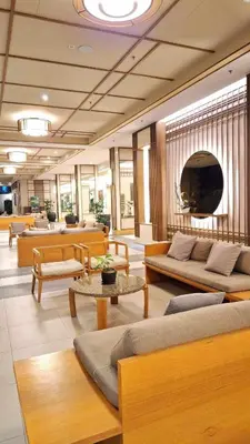 a lobby with couches and tables in a building at Jungle Escape in Manila